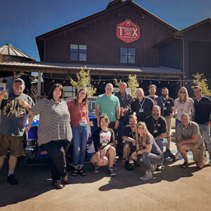 Group shot of DoubleDave's team in front of a brewery